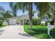 Charming single-story home featuring a well-manicured lawn, mature trees and inviting front entrance at 3404 W Villa Rosa St, Tampa, FL 33611
