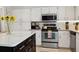 Bright kitchen features an island, stainless steel appliances and white cabinetry at 3404 W Villa Rosa St, Tampa, FL 33611