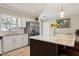 Bright kitchen features an island with eat in seating, stainless steel appliances, and lots of sunlight at 3404 W Villa Rosa St, Tampa, FL 33611