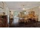 Spacious dining room extending into a sitting room filled with natural light and hardwood flooring at 3404 W Villa Rosa St, Tampa, FL 33611