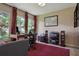 Bright home office with a large window overlooking lush greenery and a decorative rug at 3404 W Villa Rosa St, Tampa, FL 33611
