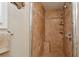 Shower stall with brown tiling, built-in bench, soap dishes, and showerhead with detachable sprayer at 3404 W Villa Rosa St, Tampa, FL 33611