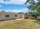 Backyard with patio, mature trees, and fully fenced yard at 3410 Grove Street Cir, Tampa, FL 33610