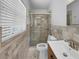 This bathroom features tile walls, a shower with glass doors, and a light and bright window at 3410 Grove Street Cir, Tampa, FL 33610
