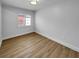 Bedroom featuring wood-look floors and a window at 3410 Grove Street Cir, Tampa, FL 33610
