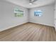 Bright bedroom featuring dual windows, wood-look floors, and a ceiling fan at 3410 Grove Street Cir, Tampa, FL 33610