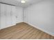 Bedroom showcasing wood-look floors and white door at 3410 Grove Street Cir, Tampa, FL 33610