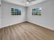 Bright bedroom with dual windows, wood-look floors, and a ceiling fan at 3410 Grove Street Cir, Tampa, FL 33610