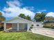 Inviting home exterior featuring a spacious carport and well-maintained front yard, perfect for outdoor enjoyment at 3410 Grove Street Cir, Tampa, FL 33610