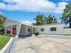 Charming single-story home featuring blue shutters and a covered carport for convenient parking at 3410 Grove Street Cir, Tampa, FL 33610