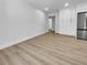 Spacious living room with wood-look floors and bright white walls at 3410 Grove Street Cir, Tampa, FL 33610