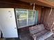 View of back porch with wooden bench swing at 359 S Orchid Dr, Ellenton, FL 34222