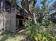 The backyard with a fenced in area, an open back deck and a lot of mature plants at 359 S Orchid Dr, Ellenton, FL 34222