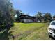 Two-story home featuring lush lawn and a backdrop of mature shade trees at 359 S Orchid Dr, Ellenton, FL 34222