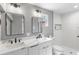 This bright bathroom features a double vanity, new fixtures, and a shower at 3926 Helena Ne St, St Petersburg, FL 33703