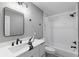 This bathroom features modern fixtures, new floors, and a shower-tub combo at 3926 Helena Ne St, St Petersburg, FL 33703