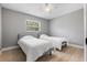 This bedroom features two beds, a ceiling fan, and a window with natural light at 3926 Helena Ne St, St Petersburg, FL 33703
