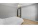 This bedroom includes a ceiling fan, a closet, and wood-look floors at 3926 Helena Ne St, St Petersburg, FL 33703