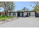 Charming single-story home with a well-maintained lawn, updated landscaping, and a light blue front door at 3926 Helena Ne St, St Petersburg, FL 33703