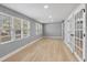 Bright living room features sleek flooring, recessed lighting, and double glass doors for ample natural light at 3926 Helena Ne St, St Petersburg, FL 33703