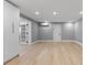 Open-concept living room with sleek flooring, modern lighting, and a stylish entryway to the other rooms at 3926 Helena Ne St, St Petersburg, FL 33703