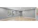 Bright living room with modern flooring, a large window, and neutral walls create a warm and welcoming atmosphere at 3926 Helena Ne St, St Petersburg, FL 33703