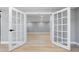 Bright living space featuring French doors, modern flooring, and recessed lighting, perfect for relaxing or entertaining at 3926 Helena Ne St, St Petersburg, FL 33703