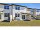Backyard with fence, lawn and sliding glass doors on modern constructed home at 6243 Daerr Ridge St, Zephyrhills, FL 33543
