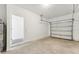 Spacious two-car garage with concrete flooring, white walls, and an overhead door at 6243 Daerr Ridge St, Zephyrhills, FL 33543