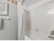 Clean bathroom featuring a shower-tub combination and neutral-colored walls at 1415 Doolittle Ln # 106, Dunedin, FL 34698