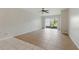 Spacious living room with tile flooring and natural light from the sliding glass doors at 1415 Doolittle Ln # 106, Dunedin, FL 34698
