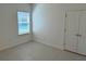 Neutral bedroom with tile flooring, window with blinds, and closet at 27206 Adams St, Punta Gorda, FL 33983