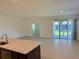 Spacious living room open to the kitchen, featuring sliding glass doors leading to the lanai at 27206 Adams St, Punta Gorda, FL 33983