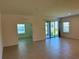Bright and airy living room features neutral tile flooring and sliding glass doors leading to outdoor space at 27206 Adams St, Punta Gorda, FL 33983