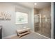 Elegant bathroom with a walk-in shower, a comfortable bench, and stylish tiled walls at 2803 Sulstone Dr, Punta Gorda, FL 33983