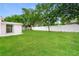 Large backyard with a well-maintained lawn and privacy fence at 6426 Eden Ln, Tampa, FL 33634