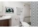 Bright bathroom with a modern vanity and shower with decorative curtain and mosaic tile detail at 6426 Eden Ln, Tampa, FL 33634