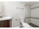 Bathroom featuring a modern vanity, toilet, and tiled shower with decorative accents at 6426 Eden Ln, Tampa, FL 33634