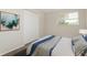 Neutral bedroom with a comfortable bed, wood-look flooring and a bright window at 6426 Eden Ln, Tampa, FL 33634