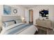 Bedroom with a comfortable bed, wood-look flooring, and stylish decor at 6426 Eden Ln, Tampa, FL 33634