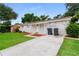 Well-maintained exterior featuring a lush front lawn, textured facade, and a welcoming entrance at 6426 Eden Ln, Tampa, FL 33634