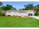 Charming single-story home featuring a well-manicured lawn, stone accents, and a classic white front door at 6426 Eden Ln, Tampa, FL 33634