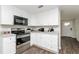 Updated kitchen with white cabinets, stainless steel appliances, and modern countertops at 6426 Eden Ln, Tampa, FL 33634