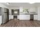 Spacious kitchen with stainless steel appliances, white cabinetry, and durable gray countertops and flooring at 6426 Eden Ln, Tampa, FL 33634