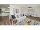 Inviting living room featuring a comfortable sofa and seamless transition to the kitchen at 6426 Eden Ln, Tampa, FL 33634