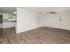 Bright living room featuring updated flooring and access to the kitchen, with fresh, neutral paint at 6426 Eden Ln, Tampa, FL 33634