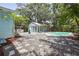 Private backyard oasis features a sparkling pool, pool house and low-maintenance gravel landscaping at 6503 N Wellington Ave, Tampa, FL 33604