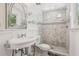 Bathroom featuring modern shower, vanity, and glass shelving with decorative mirror at 6503 N Wellington Ave, Tampa, FL 33604