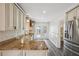 Bright kitchen with granite countertops, stainless steel appliances, and white cabinets at 6503 N Wellington Ave, Tampa, FL 33604