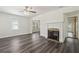 Bright living room with fireplace, ceiling fan and hardwood floors at 6503 N Wellington Ave, Tampa, FL 33604